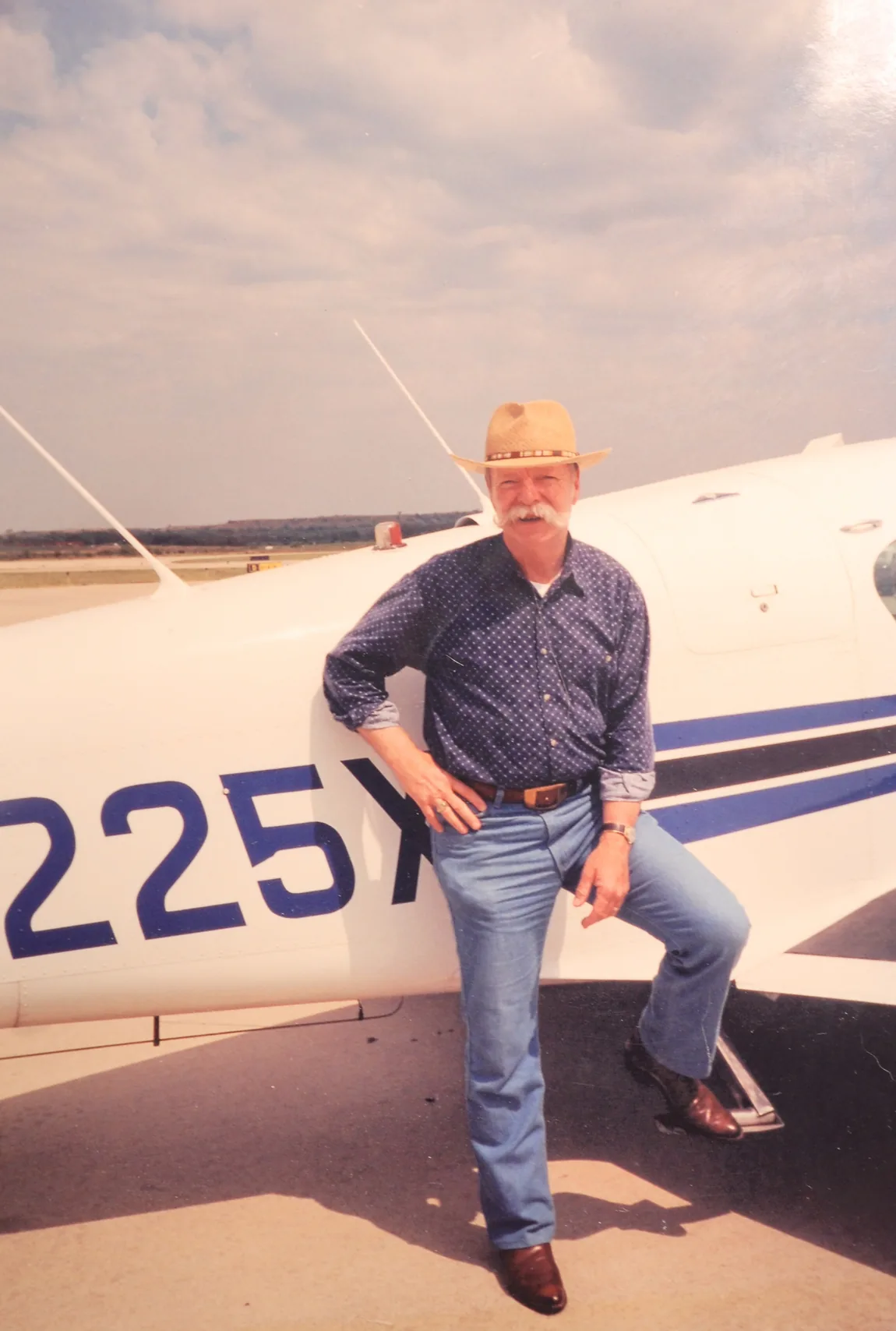 Seth's grandpa standing with his Mooney aircraft